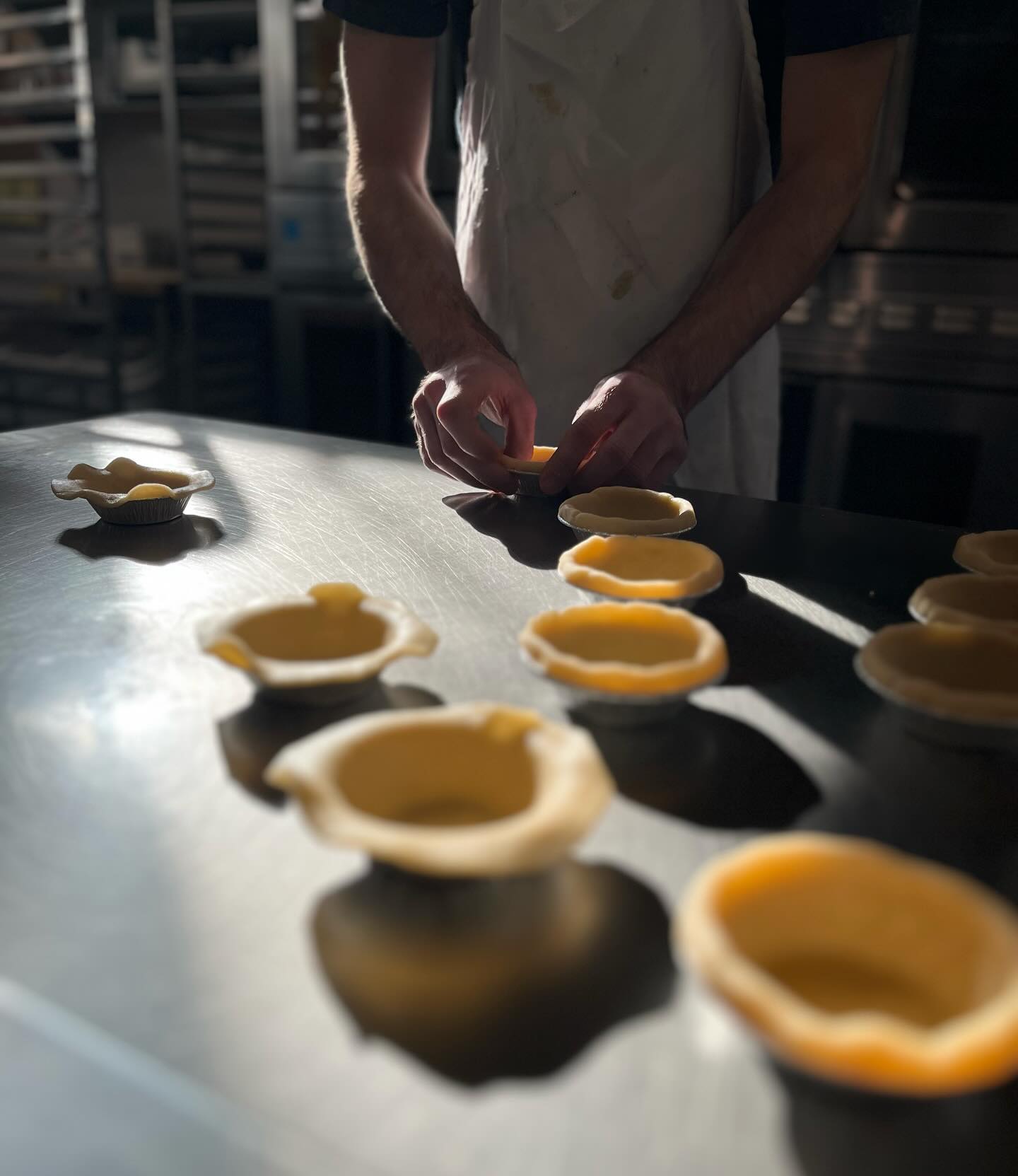 Mini pie preparation and sunlight in the bakery today